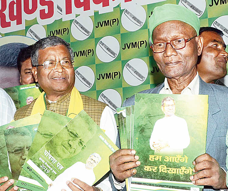 Babulal Marandi (left) releases the party manifesto in Ranchi on Wednesday