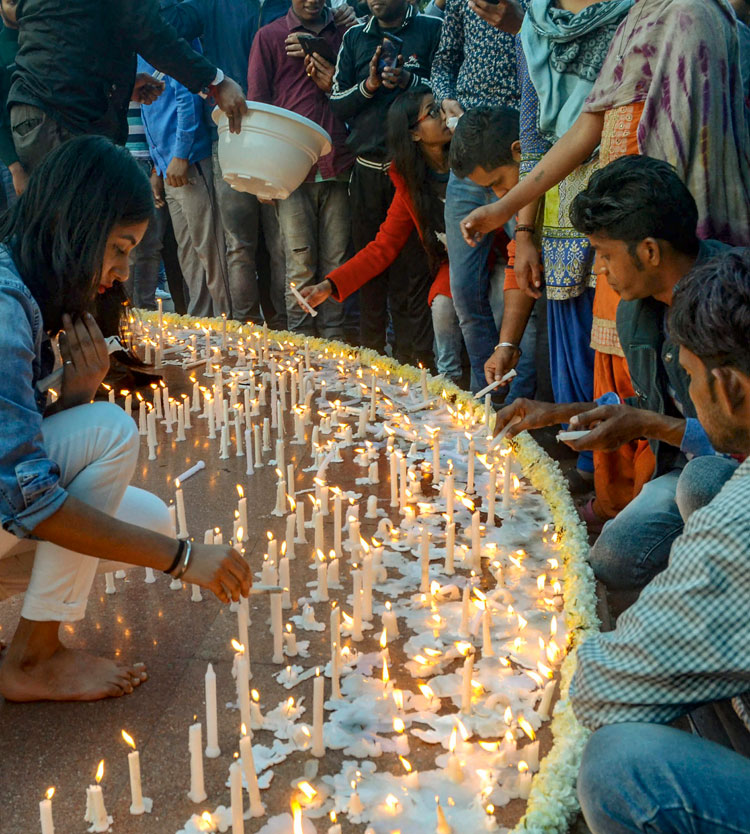 People light candles to pay tribute to CRPF soldiers who lost their lives in Pulwama terror attack, at Connaught Place in New Delhi on Sunday, February 17.