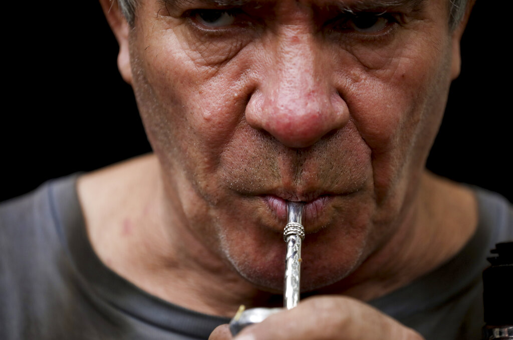 Oscar Brun drinks "mate" at his ironworks shop in Buenos Aires, Argentina. Brun said one prepares "mate" to share it and be social. In Uruguay, Paraguay and Argentina, drinking and sharing the herb "mate" is a tradition among family members, office colleagues and schoolmates, who share the straw as they pass the drink around. Today, however, the spread of the new coronavirus outbreak has made people quit sharing.