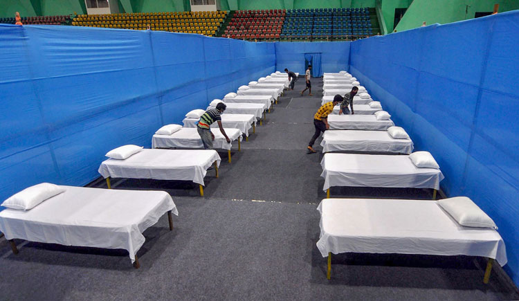  Workers prepare beds inside a quarantine facility for COVID-19 patients, during a nationwide lockdown in the wake of coronavirus pandemic in Guwahati on Sunday