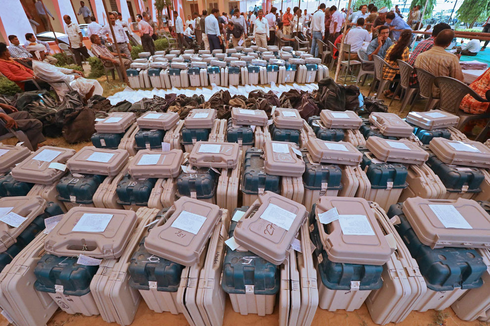 Polling officials collect EVMs and other materials from a distribution centre in Jaipur on Sunday