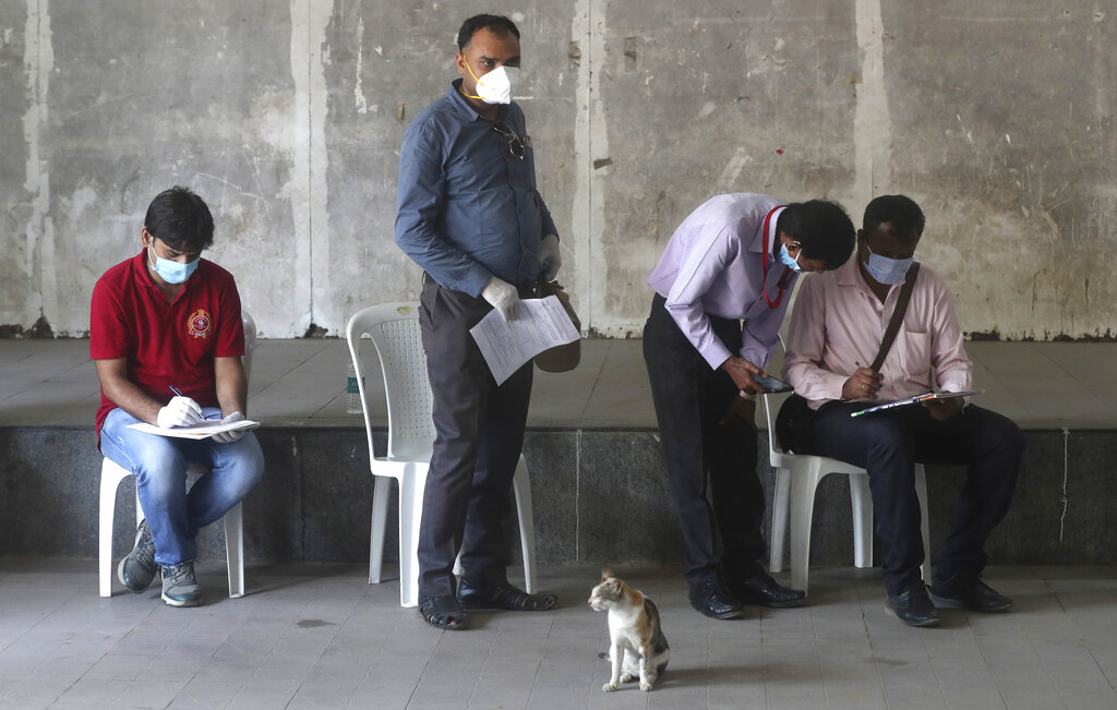 Journalists fill in their details for a swab test during lockdown to control the spread of the new coronavirus in Mumbai, on Thursday, April 16, 2020.