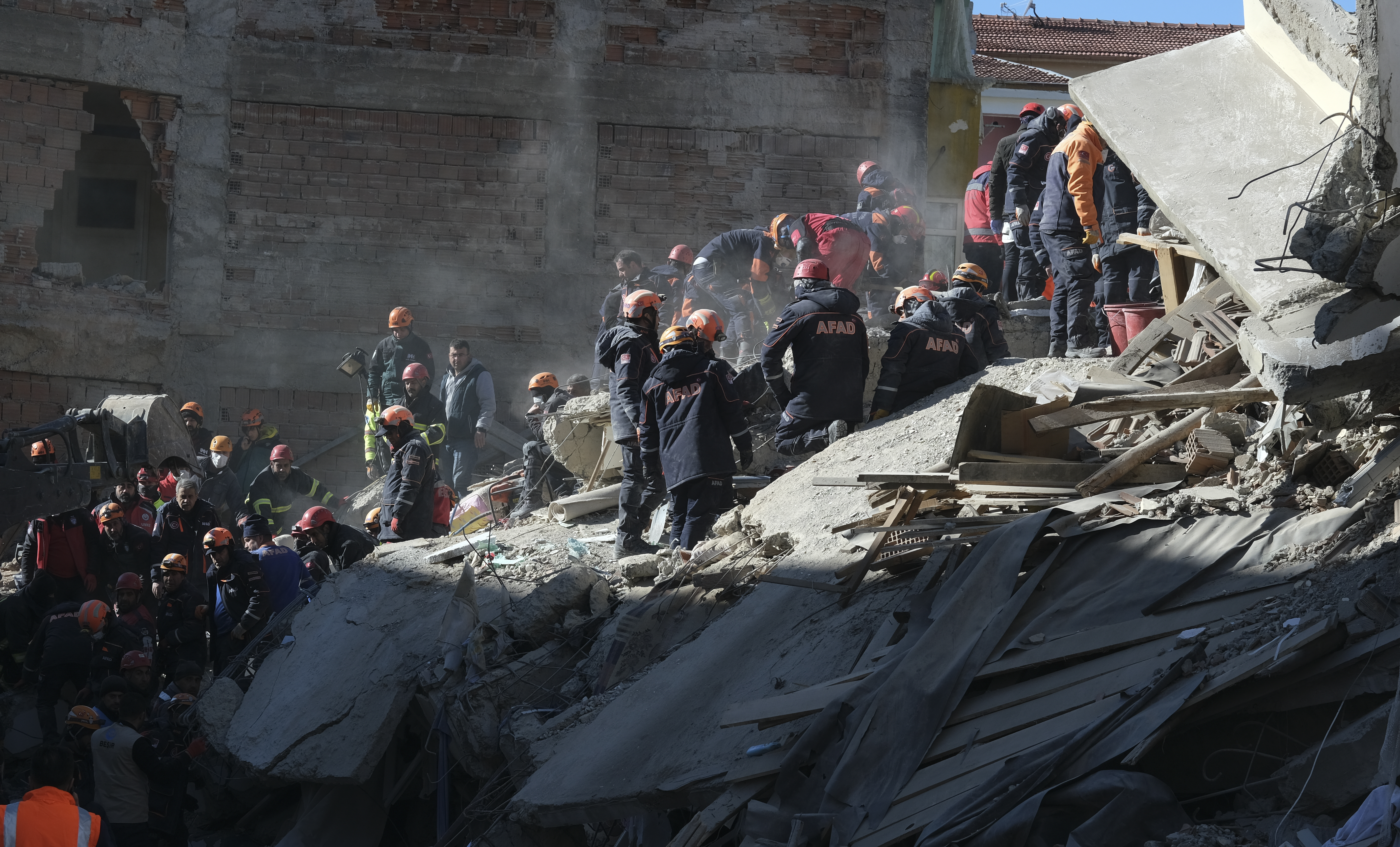 Rescuers work on searching for people buried under the rubble on a collapsed building, after an earthquake struck Elazig, eastern Turkey, on January 25, 2020