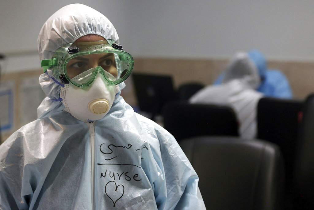 A nurse wears protective gear in a ward dedicated for people infected with the new coronavirus, at a hospital in Tehran