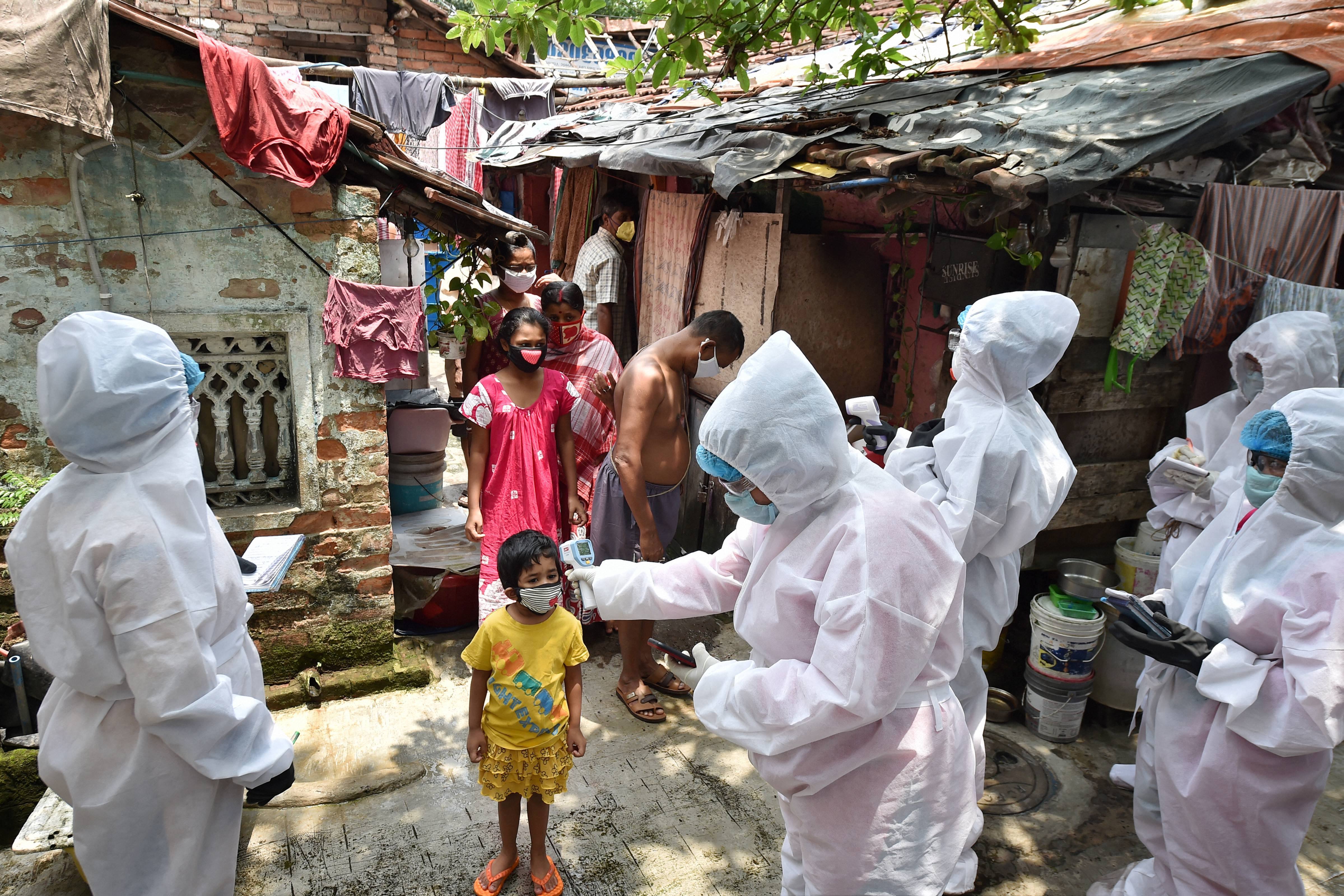 Health workers wearing protective gear during a door-to-door thermal screening at a slum area to detect Covid-19 positive cases, amid the ongoing nationwide lockdown, in Kolkata, Saturday, May 02, 2020.