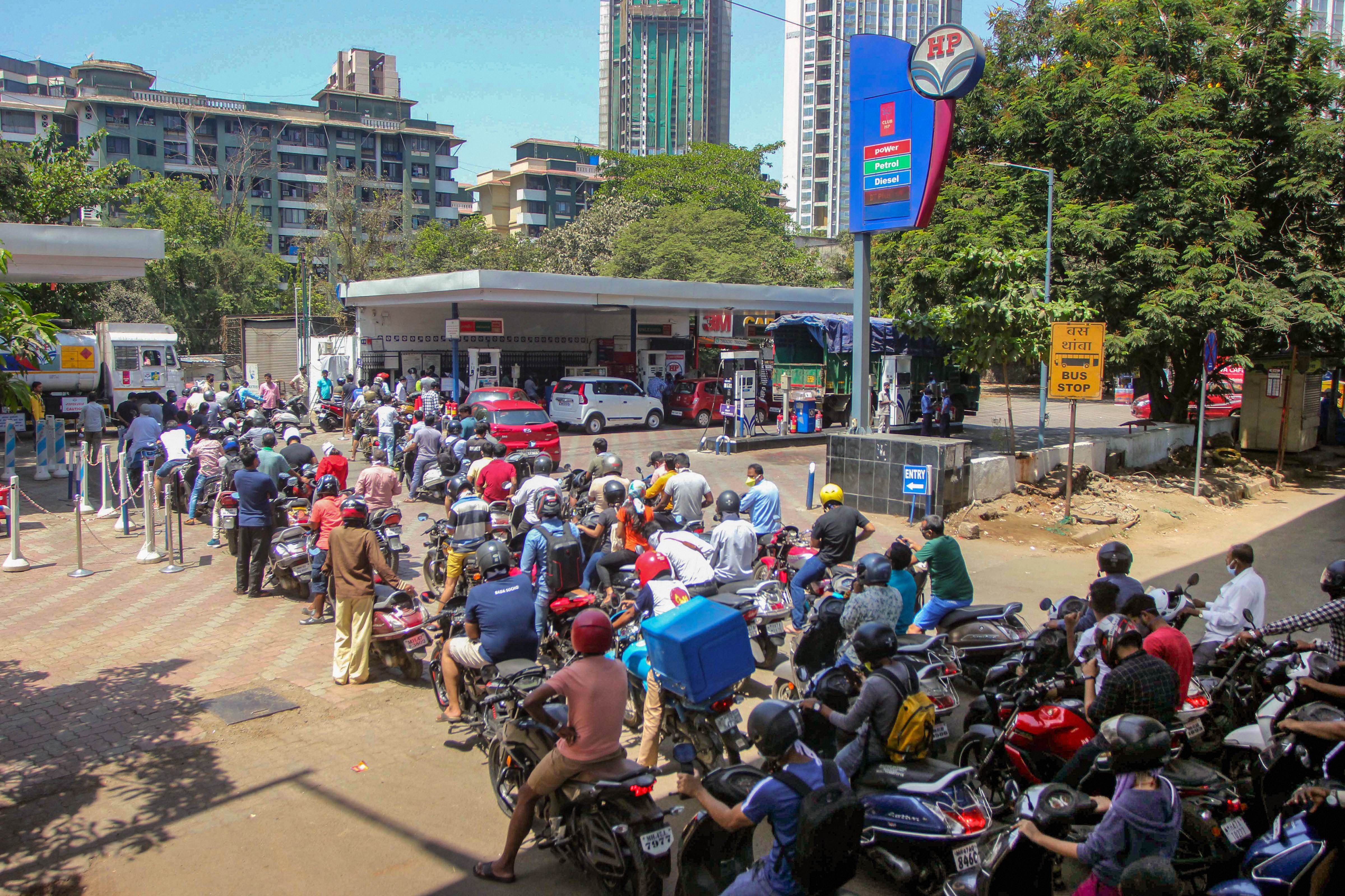People rush with their vehicles rush to petrol pumps to fill tanks during the lockdown in the wake of coronavirus outbreak in Thane, Mumbai, Monday, March 23, 2020
