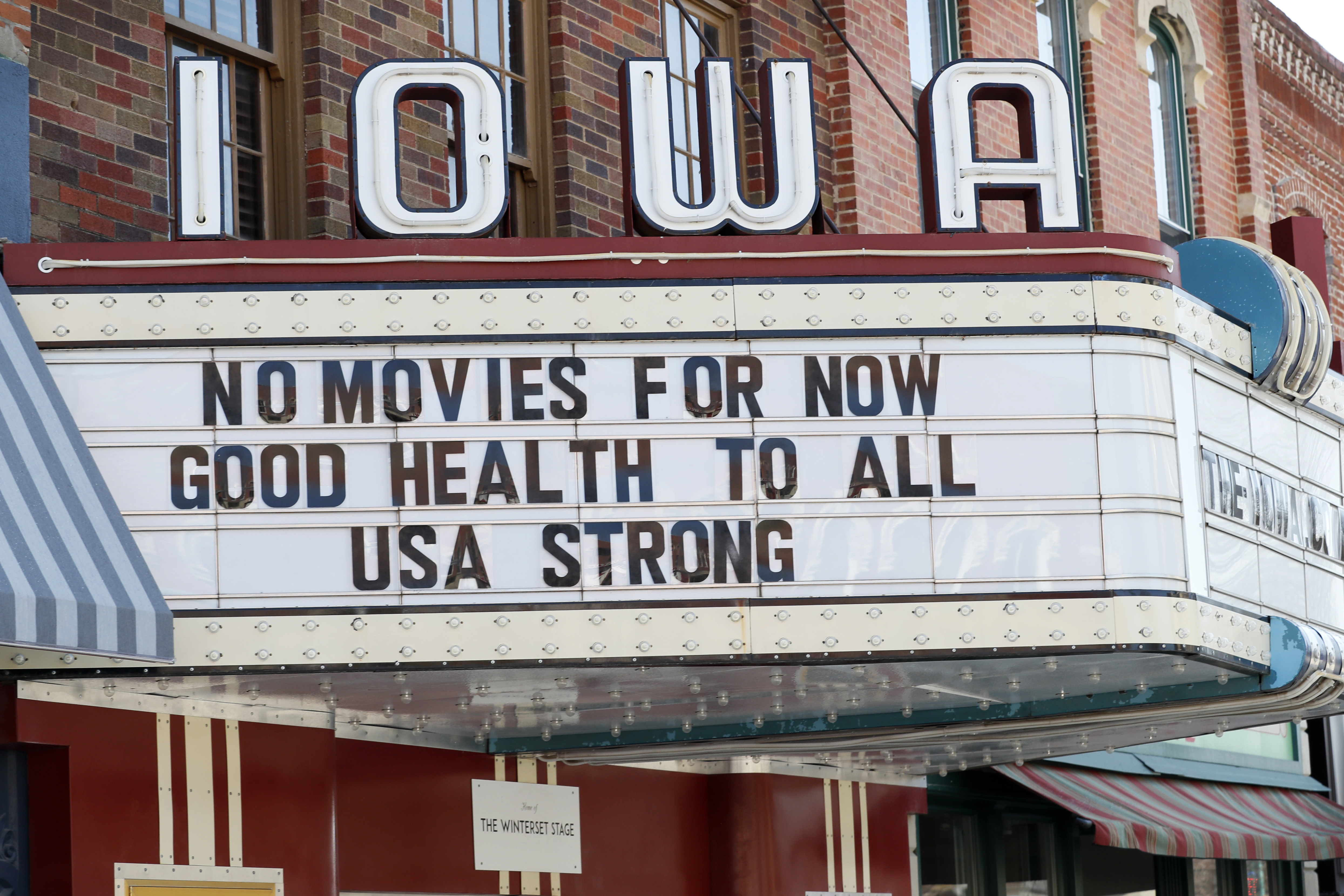 The marquee for the Iowa Theater, closed in response to the coronavirus outbreak, is seen on John Wayne Drive in Winterset, Iowa