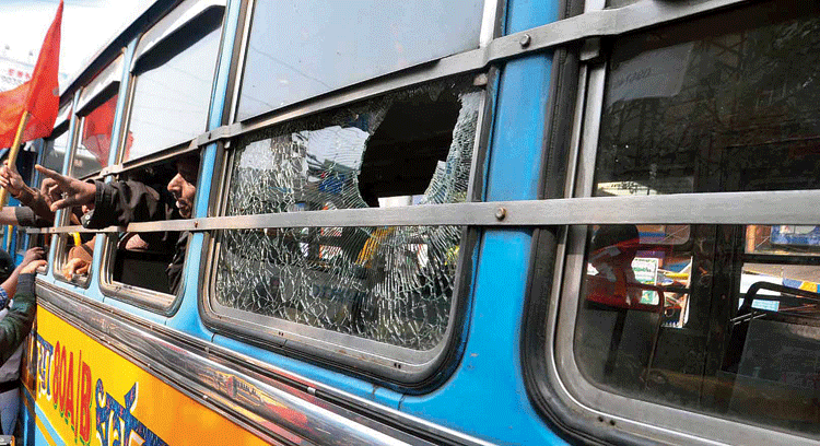 A bus with a smashed window on Rashbehari Avenue