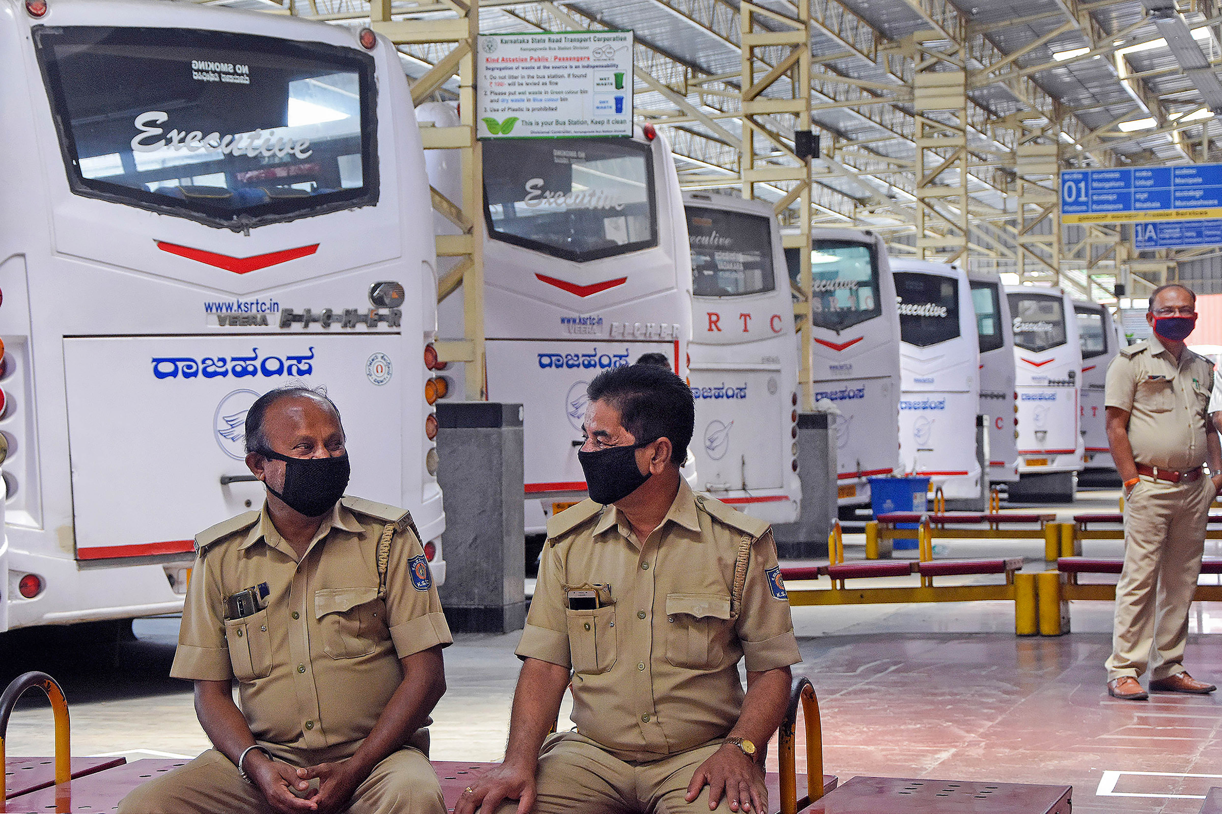 KSRTC employees at a bus stop in Bangalore on Monday. 