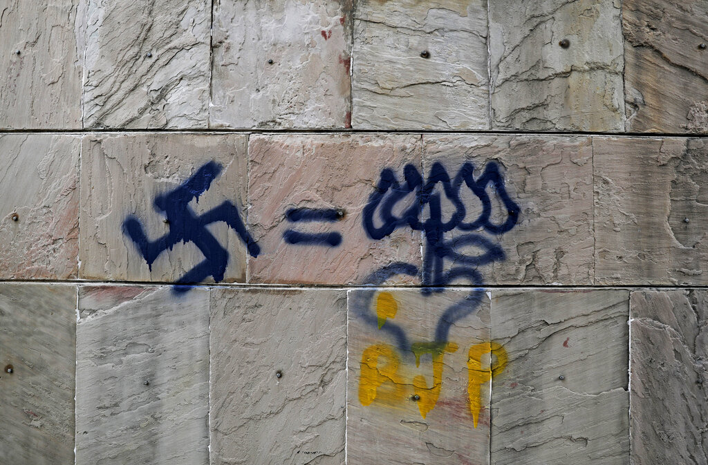Graffiti in Jamia Millia Islamia that equates Nazi's Swastika with Lotus (BJP's election symbol), spray-painted in the university