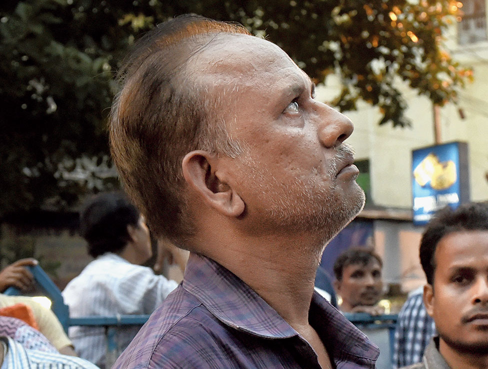 An anxious trader look up at the blaze.