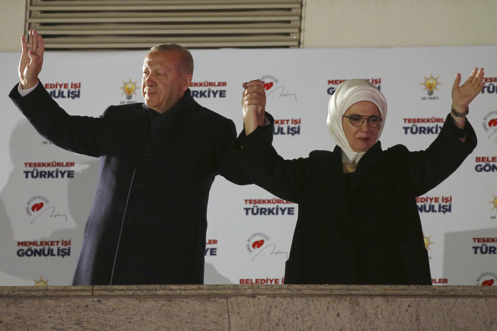 Erdogan and his wife Emine greet supporters in Ankara early on Monday.