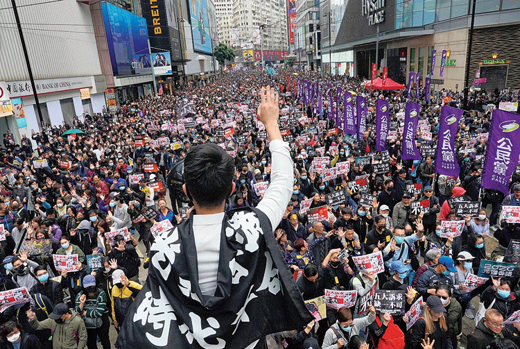 A protester in Hong Kong on Wednesday gestures as demonstrators take part in a pro-democracy march in Hong Kong on Wednesday. 
