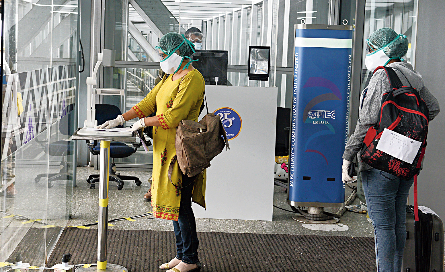 Contact-less checking of ticket and photo identity. Passenger places ticket and photo ID under a camera. The visuals are displayed on a screen on which a Central Industrial Security Force personnel checks the documents