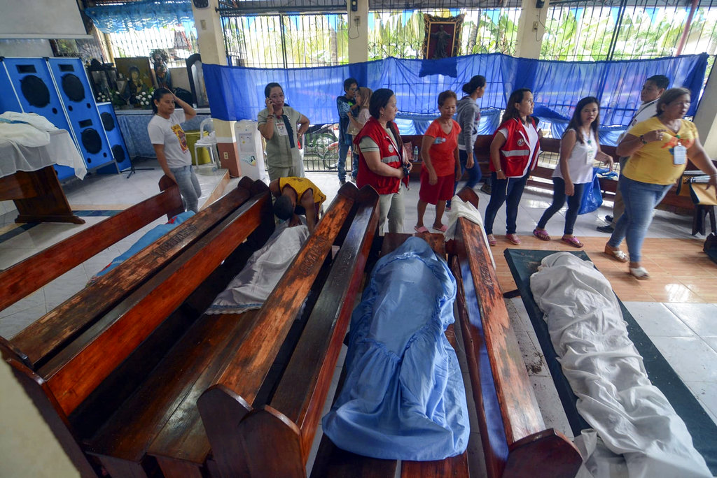 Dead victims stay inside a chapel after they were recovered from a landslide as it struck homes in Naga city.