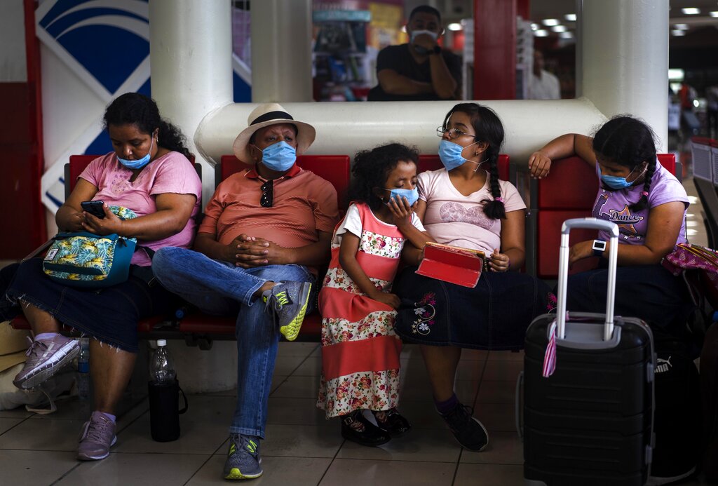 Tourists from Mexico wearing masks as a precaution against the spread of the new coronavirus, wait for their flight home, at the Jose Marti International Airport in Havana, Cuba, Monday, March 23, 2020. The vast majority of people recover from the COVID-19 disease.