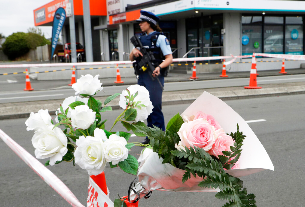 A police officer stands at a police cordon at an intersection near the Linwood Mosque in Christchurch, New Zealand on Sunday, March 17, 2019.