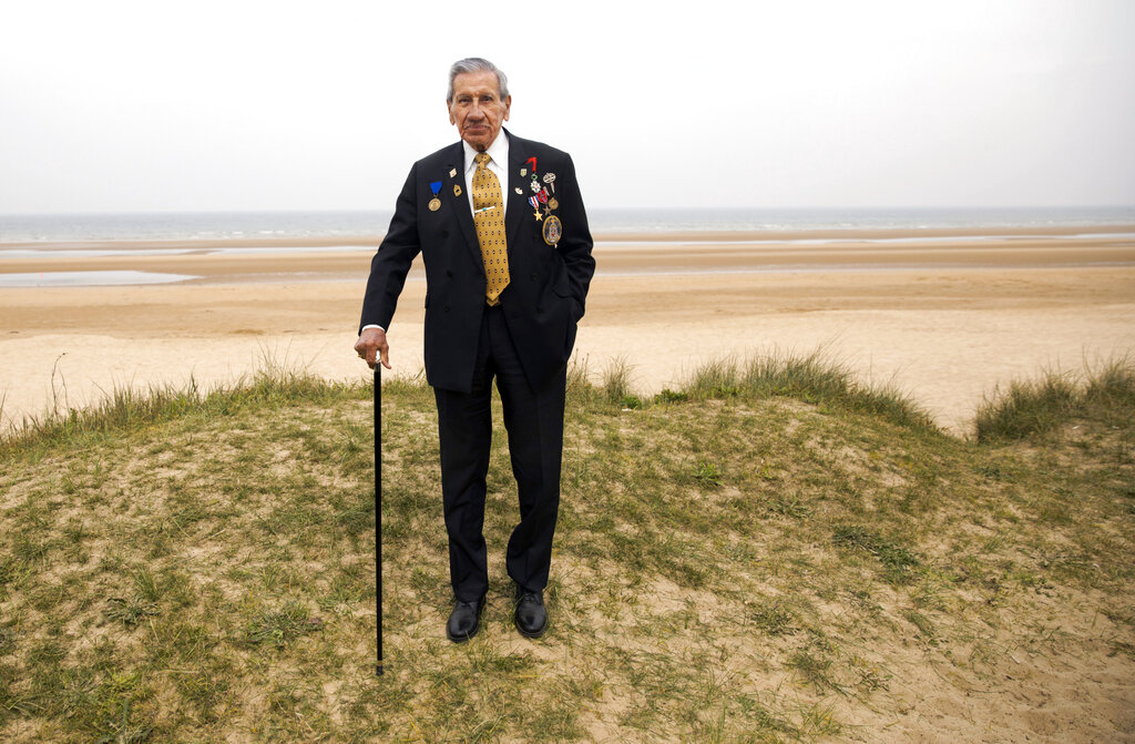 World War II and D-Day veteran Charles Norman Shay, from Indian Island, Maine, poses on a dune at Omaha Beach in Saint-Laurent-sur-Mer, Normandy. Shay was a combat medic on D-Day, assigned to an assault battalion in the first wave of attacks on D-Day, June 6, 1944.