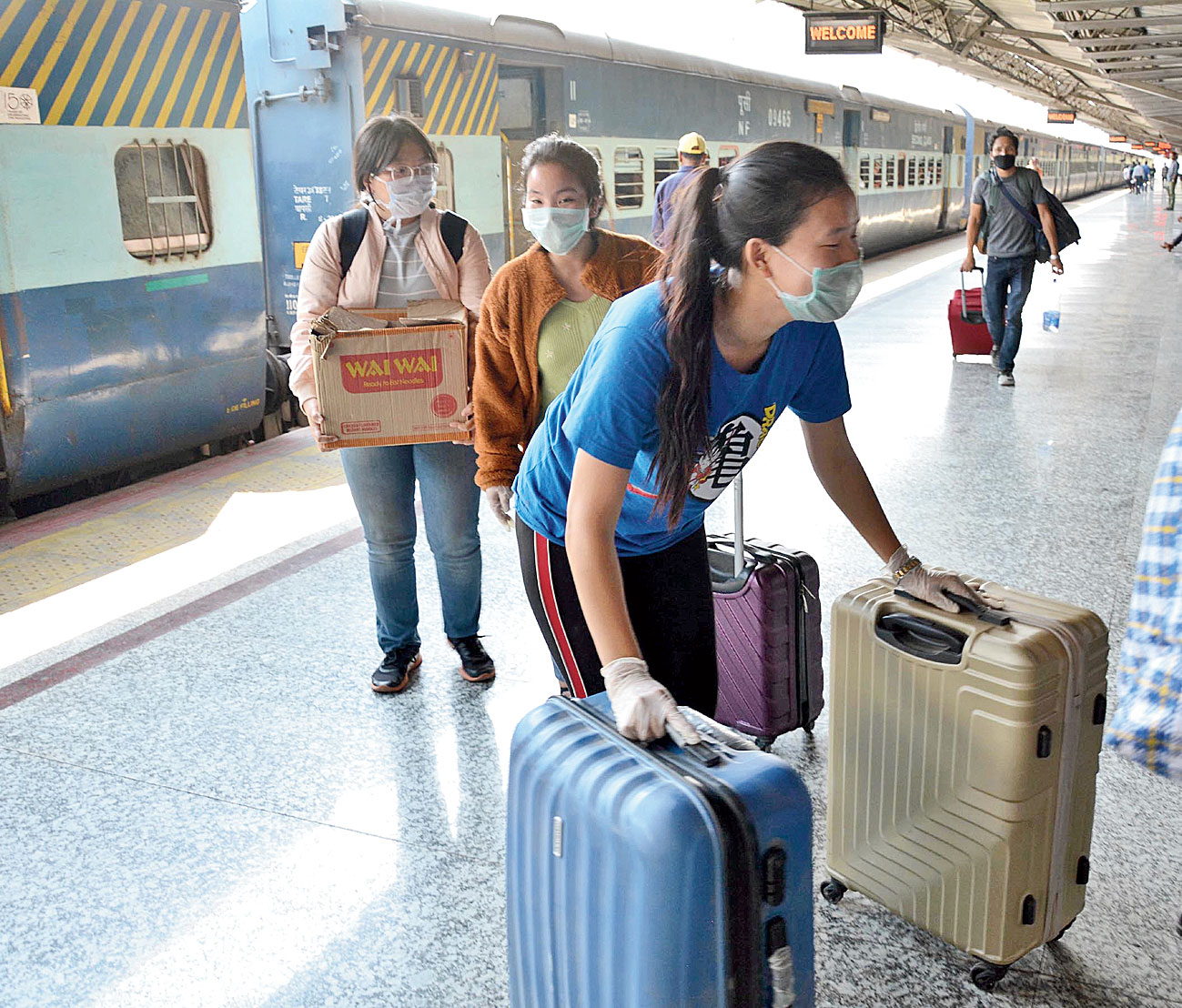 Passengers wear protective masks at Guwahati railway station on Wednesday. 