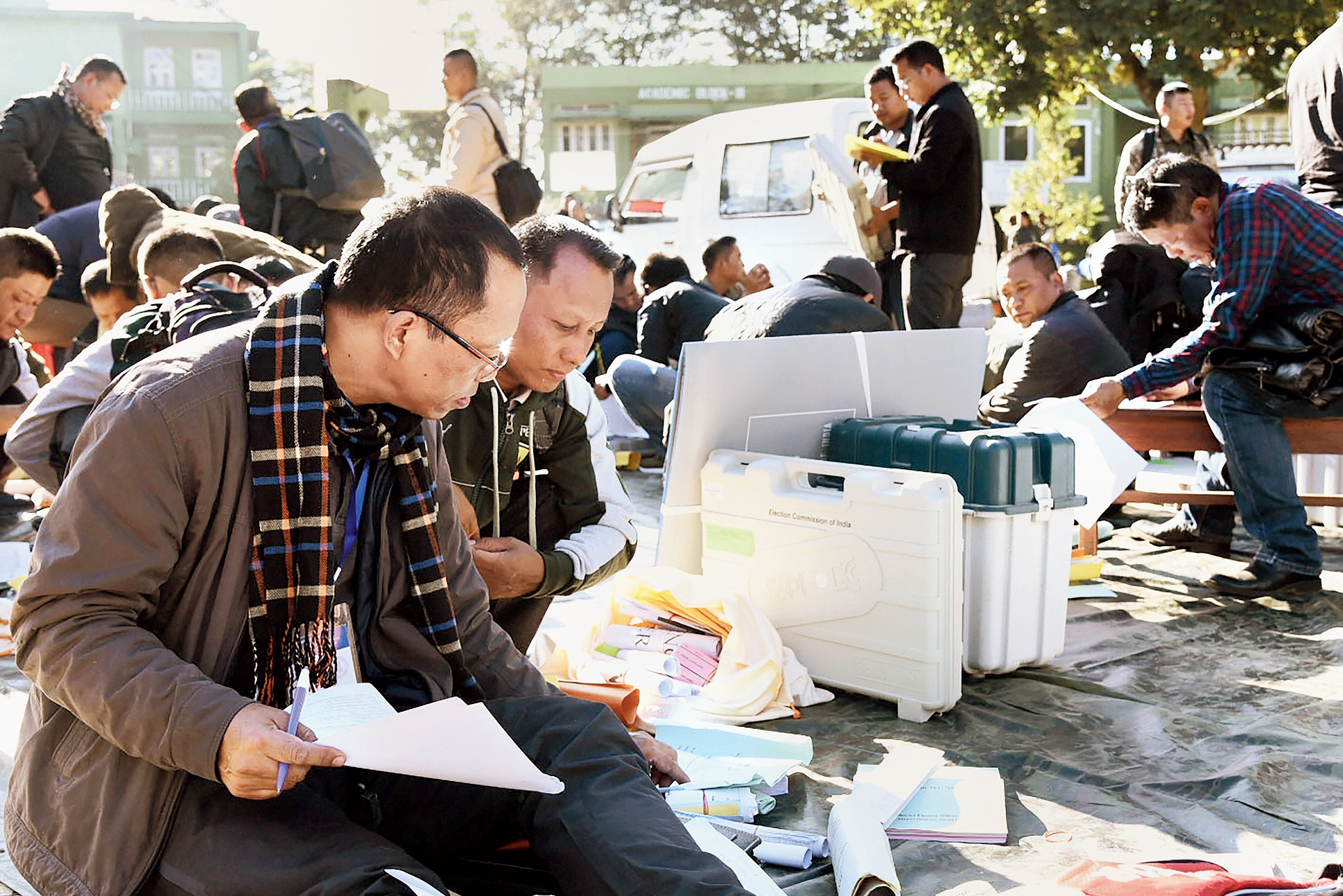 Poll officials collect EVMs and other election materials from a distribution centre in Aizawl on Tuesday.