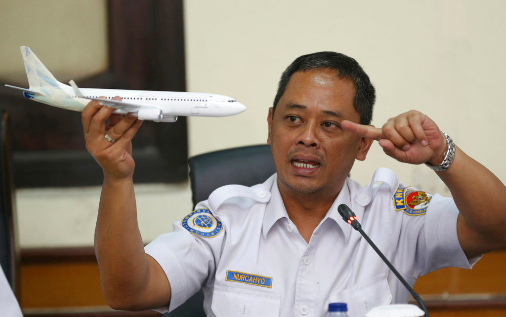 National Transportation Safety Committee investigator Nurcahyo Utomo holds a model of an airplane during a press conference on the committee's preliminary findings on their investigation on the crash of Lion Air flight 610, in Jakarta, Indonesia, Wednesday, November 28, 2018.