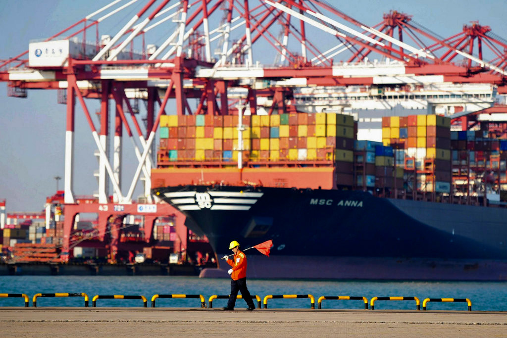 In this photo dated Oct. 12, 2018, a worker walks by the container ship docked at a port in Qingdao in east China's Shandong province.