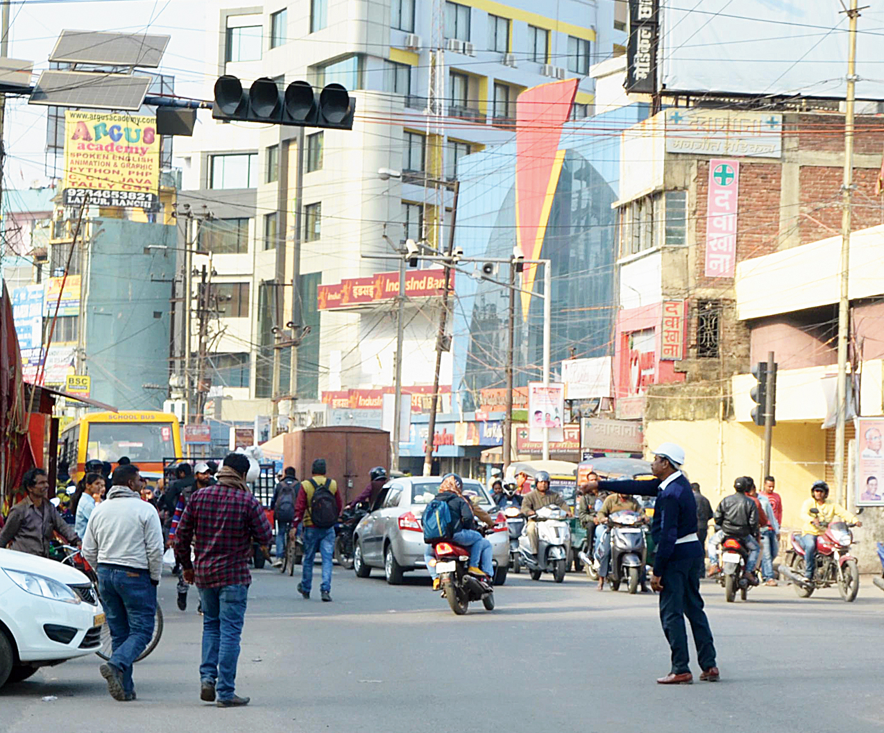 A traffic cop manages vehicles as the signal conks out at Lalpur Chowk.