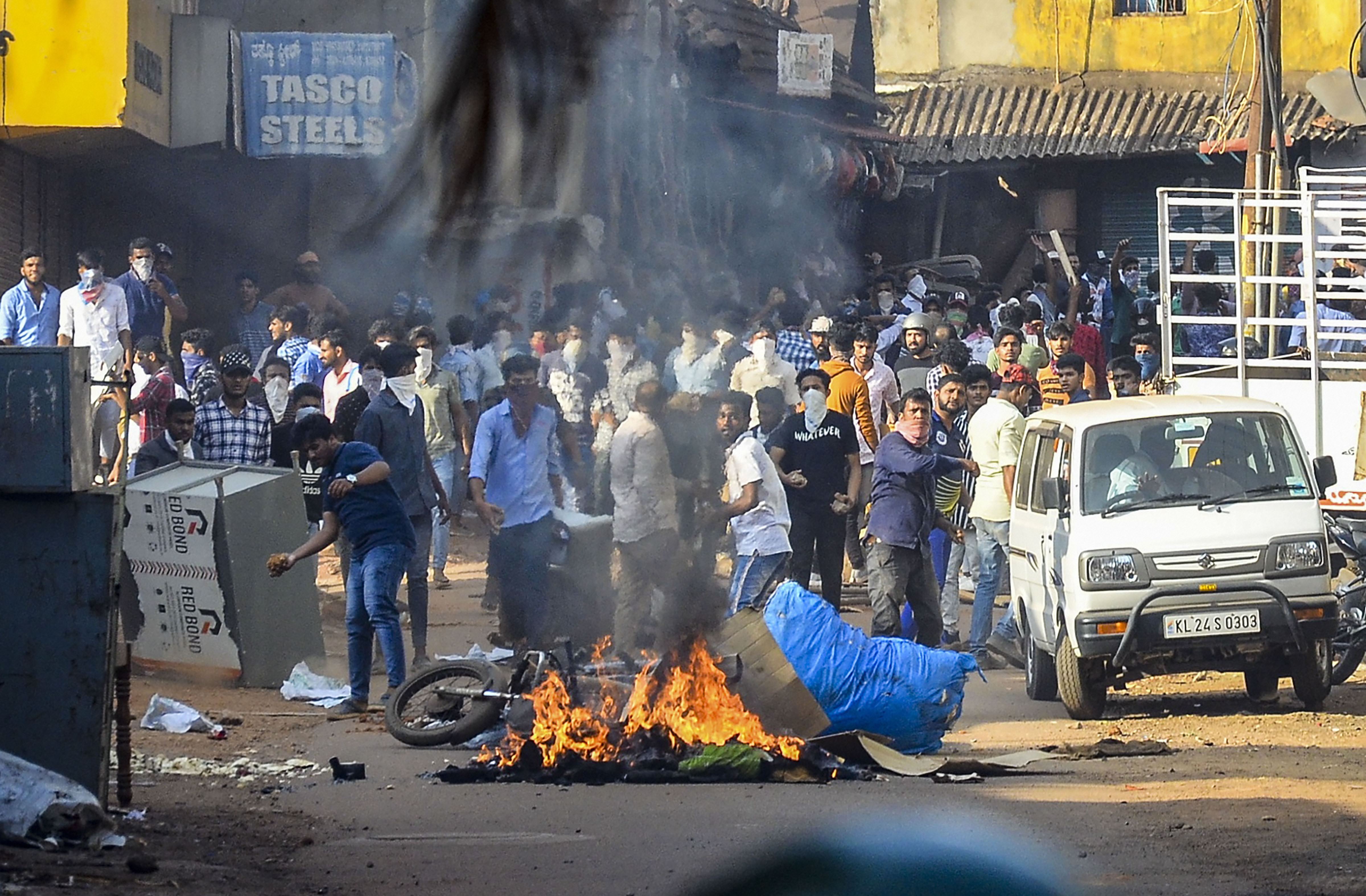Police personnel and protesters clash during a rally against the amended Citizenship Act and the NRC exercise, in Mangaluru, Thursday, December 19, 2019