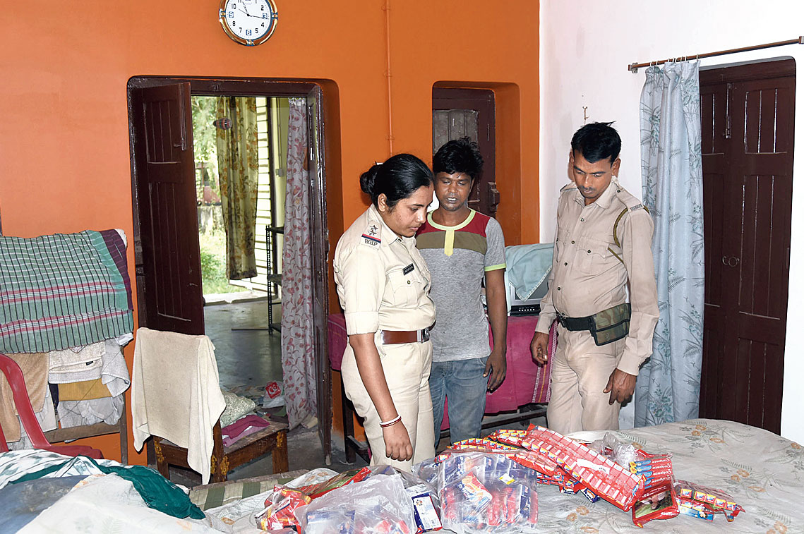 Police inspect the home after the theft on Wednesday.