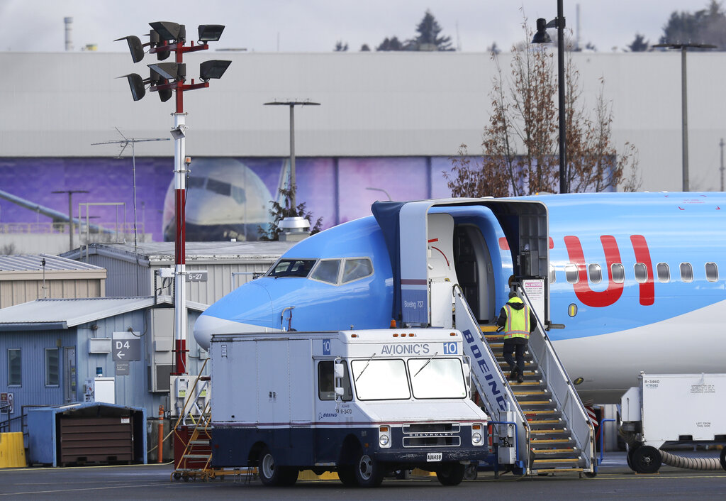 A worker walks up steps to the right of an avionics truck parked next to a Boeing 737 MAX 8 airplane being built for TUI Group at Boeing Co.'s Renton Assembly Plant on Wednesday.