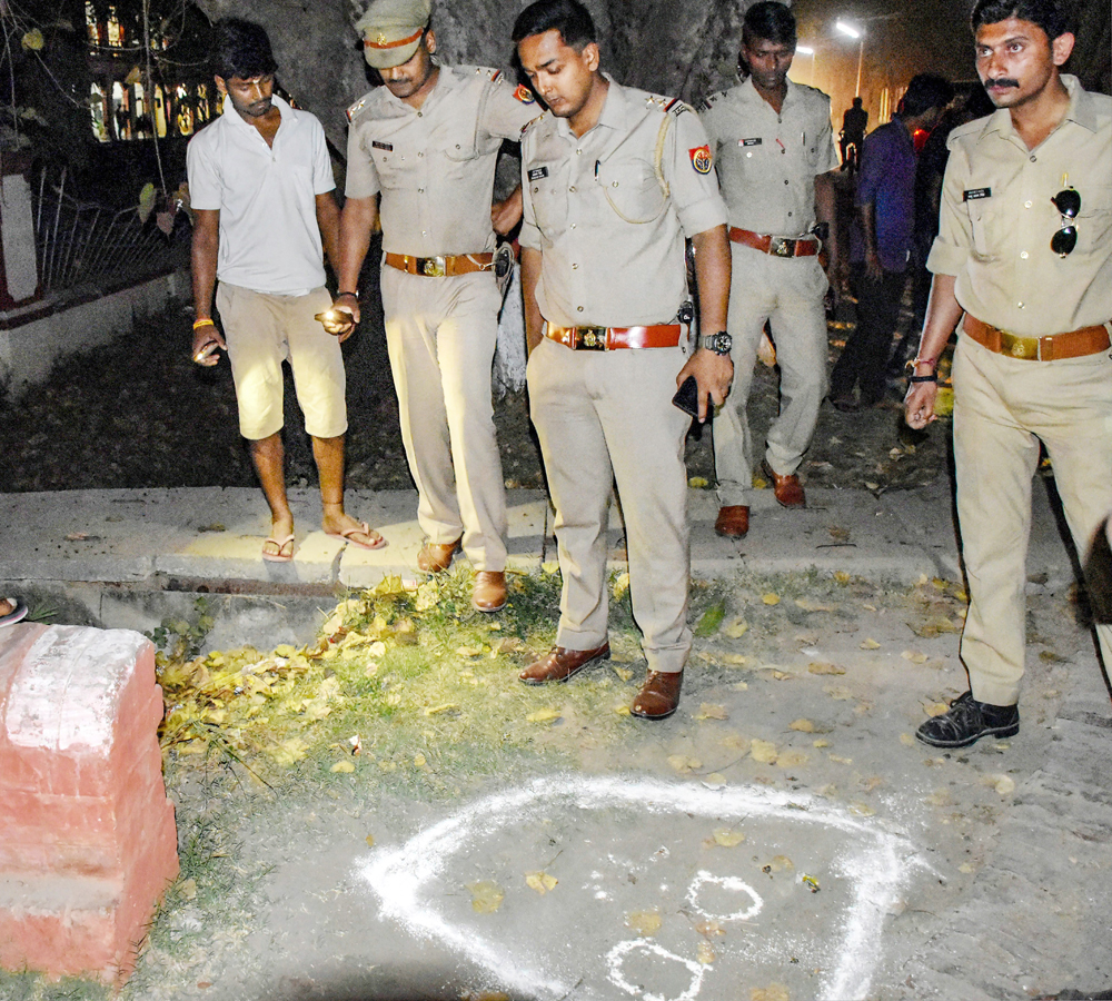 Police inspect the spot where suspended Gaurav Singh was shot at by unidentified assailants outside a hostel on the University campus.