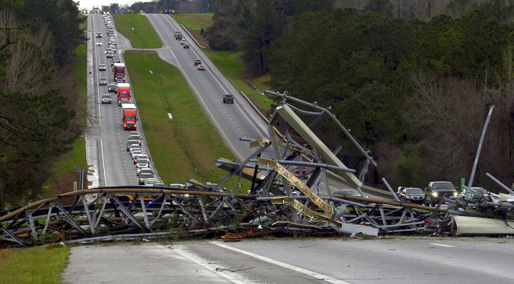 A fallen cell tower lies across US Route 280 highway in Lee County, Alabama.