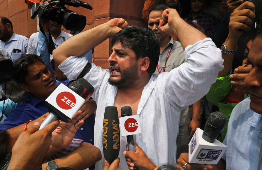 PDP lawmaker Fayaz Ahmed Mir shouts slogans against the Indian government's proposal to revoke disputed Kashmir's special constitutional status at the Parliament house in New Delhi, India, Monday, August 5, 2019. 