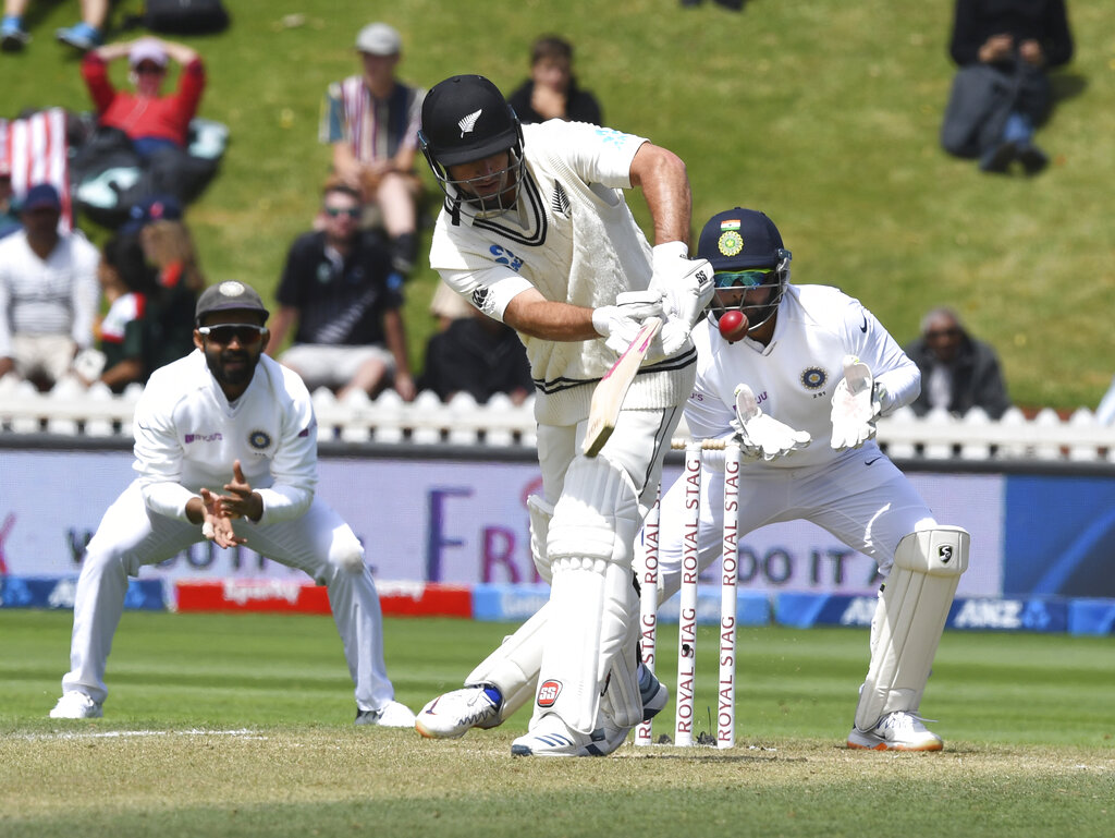 Rishabh Pant, right, waits for the catch to dismiss New Zealand's Colin de Grandhomme for 43 during the first cricket test between India and New Zealand at the Basin Reserve in Wellington, New Zealand, Sunday, February 23, 2020
