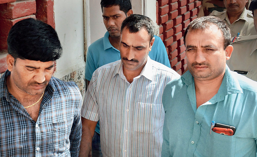 Mahipal (centre) being taken to a court in Gurgaon on Sunday. 