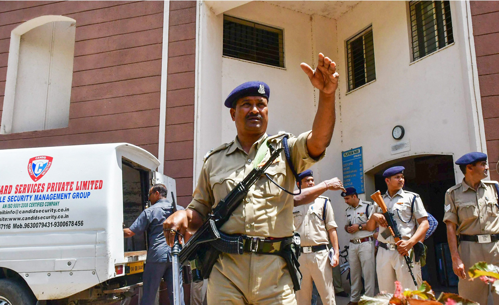 CRPF jawans guard as Income Tax officials recover cash after raids at the premises of lobbyist Ashwini Sharma in Bhopal on Monday, April 8, 2019. 