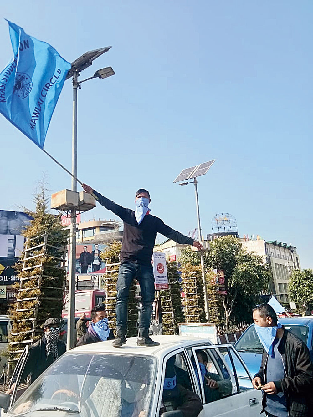 An activist waves a KSU flag in Shillong.