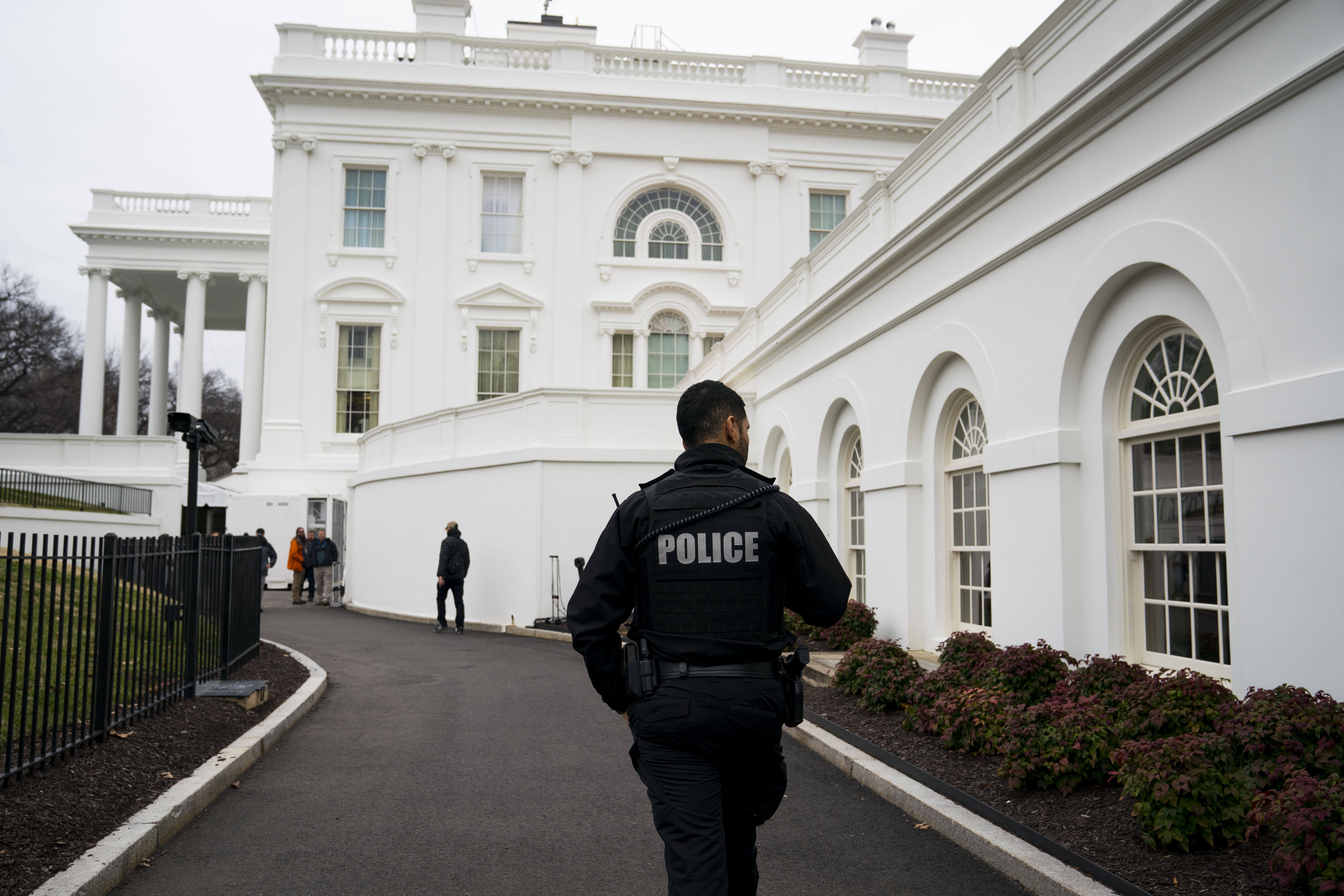 A member of the Secret Service walks around the grounds of the White House on Friday.