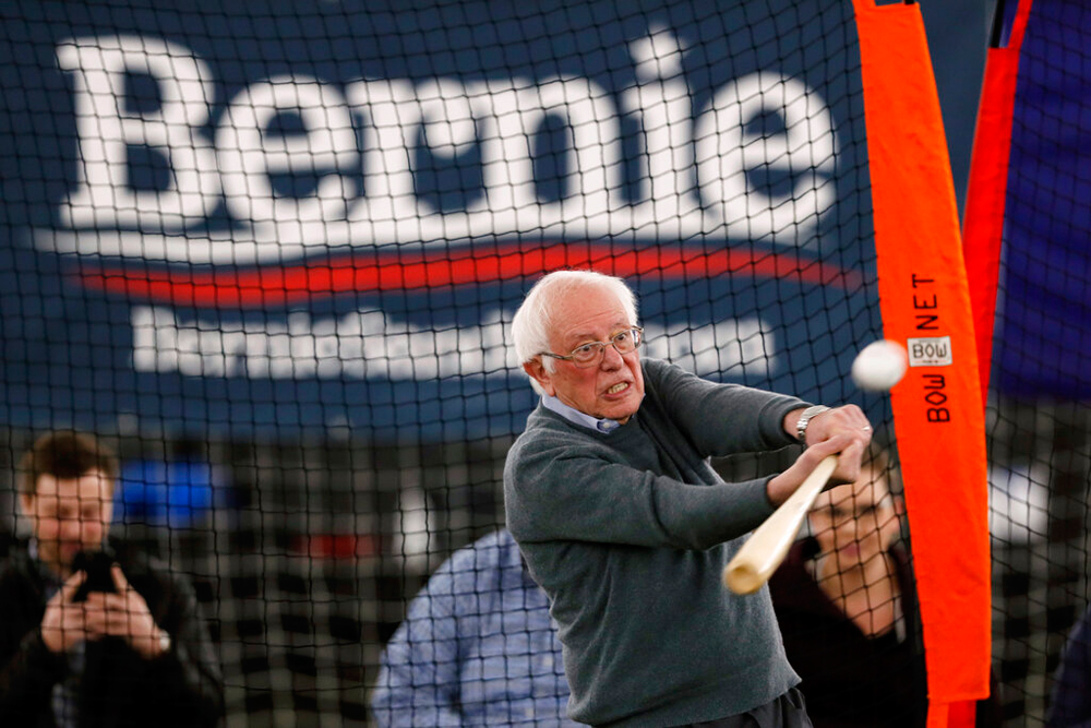 Bernie Sanders hits a baseball in Burlington, Iowa, on Sunday
