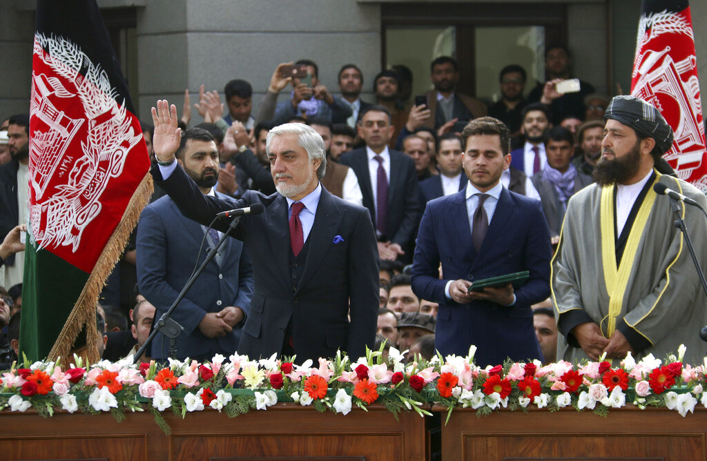 In this Monday, March 9, 2020, photo, Afghanistan's Abdullah Abdullah, front left, greets his supporters after being sworn in as president in Kabul, Afghanistan.