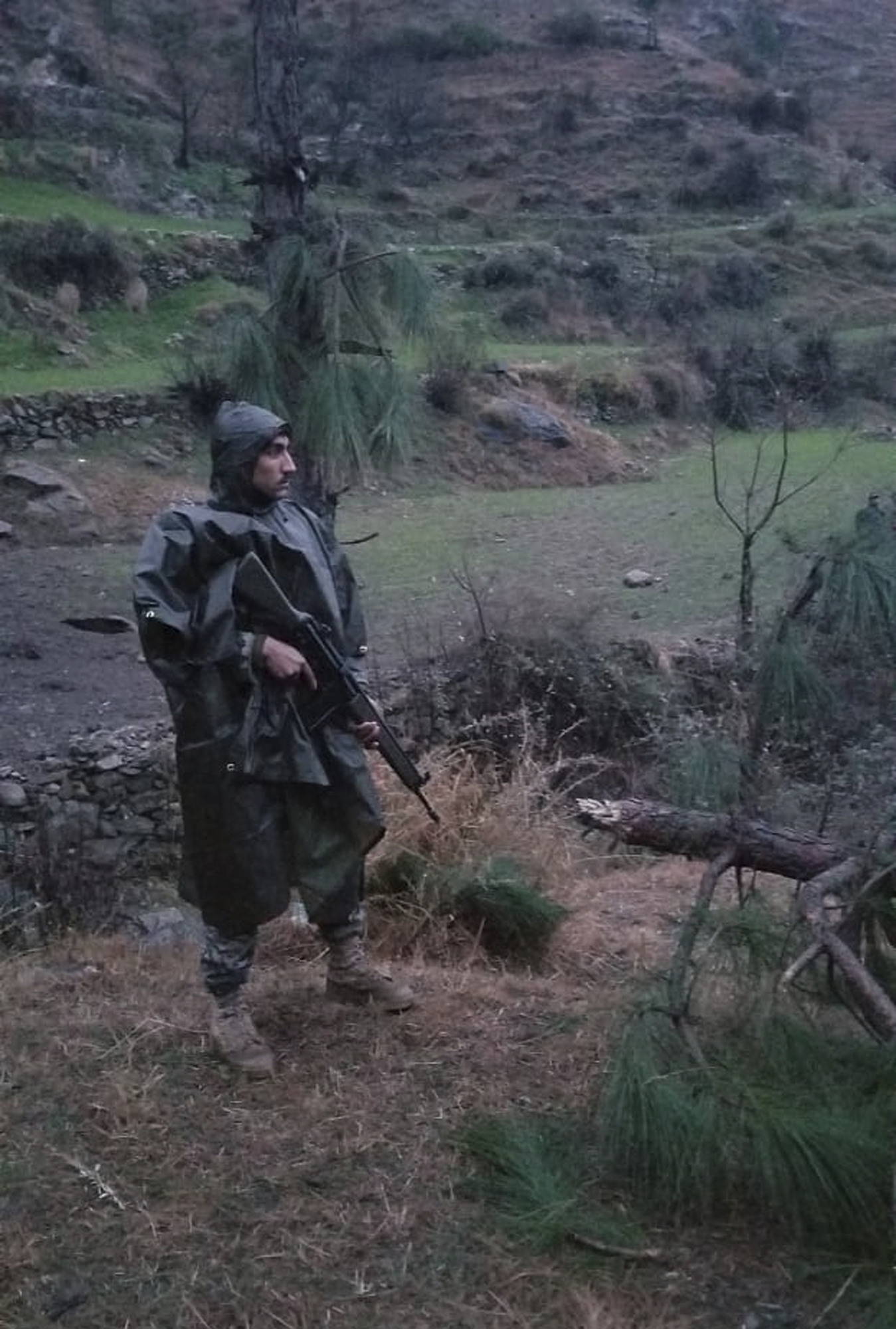 A Pakistani soldier stands guard in the area where Indian jets struck near Balakot.