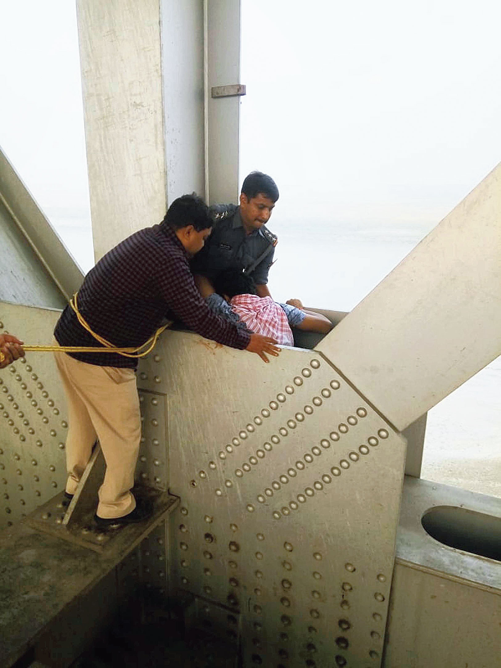 The rescuers lift the trapped youth