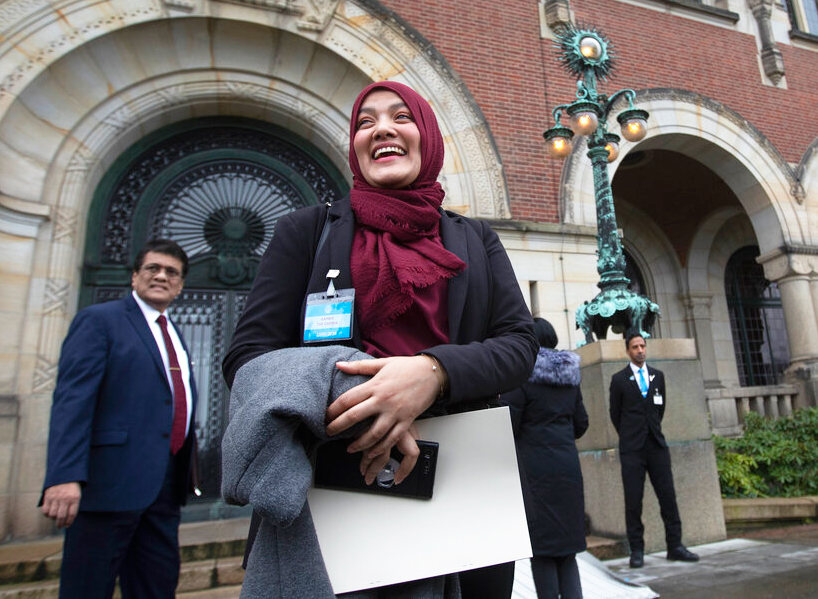 Yasmin Ullah, a member of the Rohingya community, is all smiles as she walks out of the International Court in The Hague, Netherlands, Thursday, January 23, 2020, after the court ordered Myanmar take all measures in its power to prevent genocide against the Rohingya.