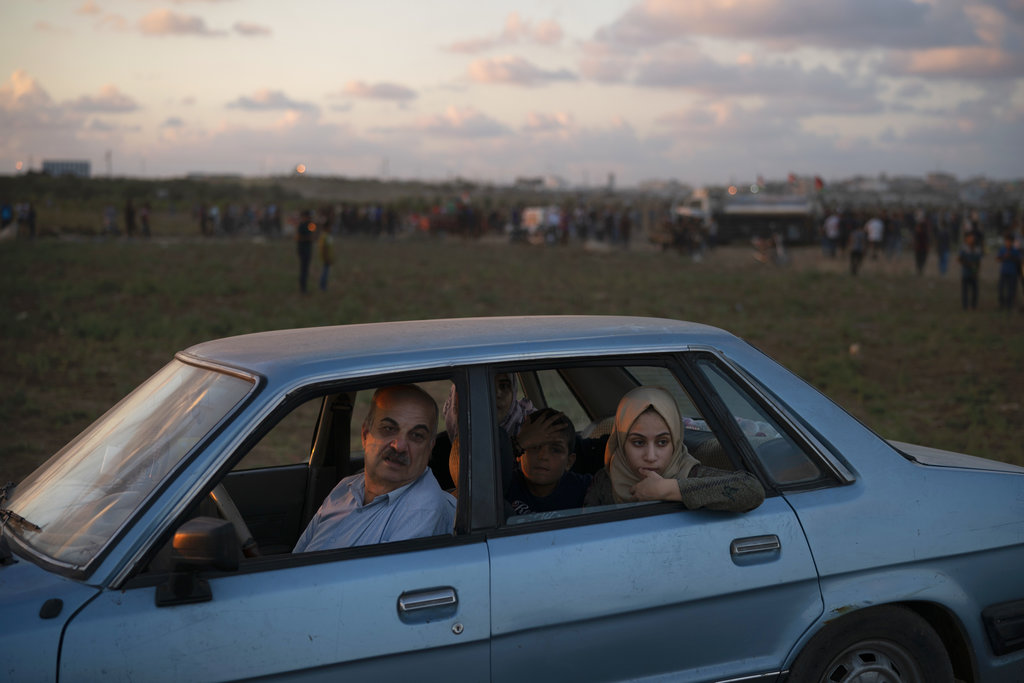 Khalil Ayesh and his family watch Palestinian protesters at the Gaza Strip's border. "I bring them every week," Ayesh said of the three children in the back seat -- his son and daughter, and his daughter's neighbour. "So they can understand what this struggle is about."
