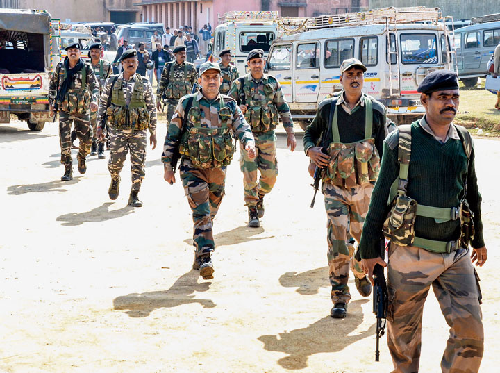 Security personnel conduct route march near Ranchi on Friday ahead of the Assembly election in Tamar constituency. 