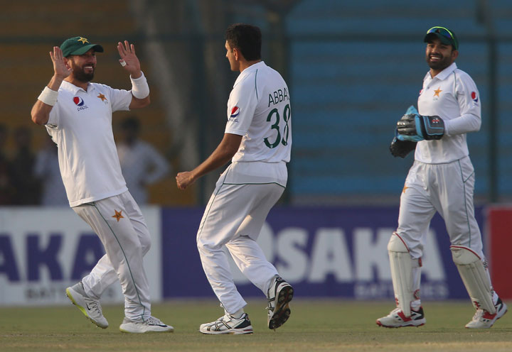 Pakistan's Yasir Shah (left) celebrates the dismissal of Sri Lankan captain Dimuth Karunaratne with bowler Mohammad Abbas during the second Test in Karachi, Pakistan, Thursday, December 19