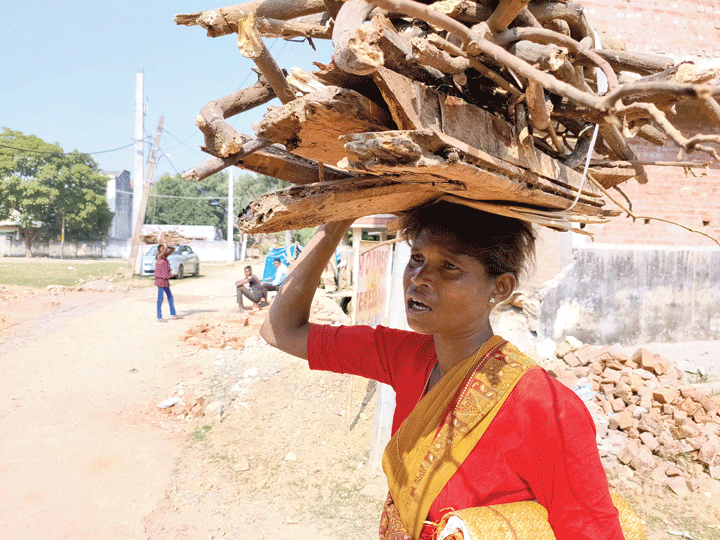 Marium Gari with a bundle of firewood on her head in Harmu, Ranchi, on Friday. 
