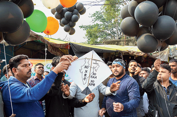 Protesters hold black balloons during the Bharat Bandh against the new citizenship matrix in Ranchi on Wednesday.