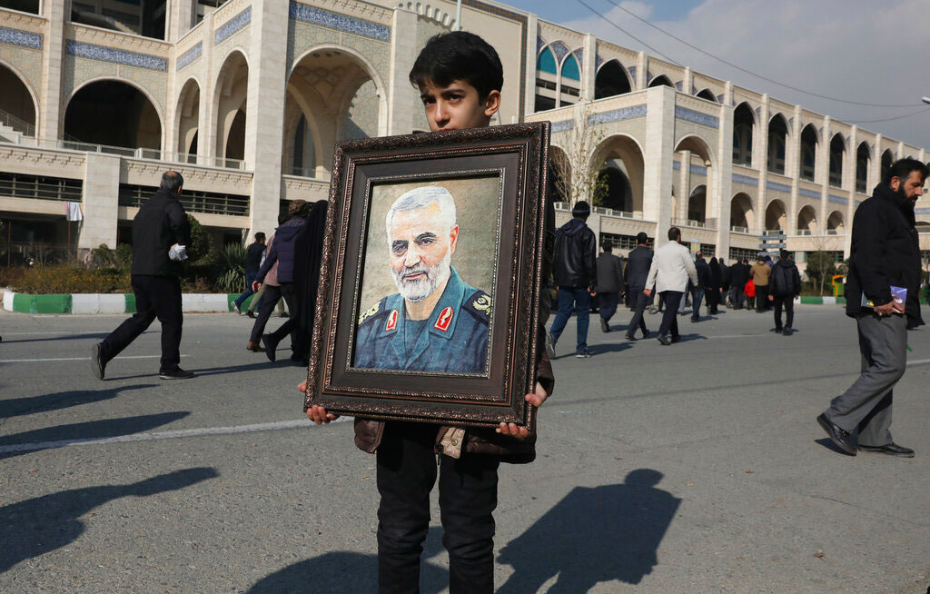 A boy carries a portrait of Iranian Revolutionary Guard Gen. Qassem Soleimani, who was killed in a US airstrike in Iraq, prior to the Friday prayers in Tehran, Iran, on January 3, 2020.