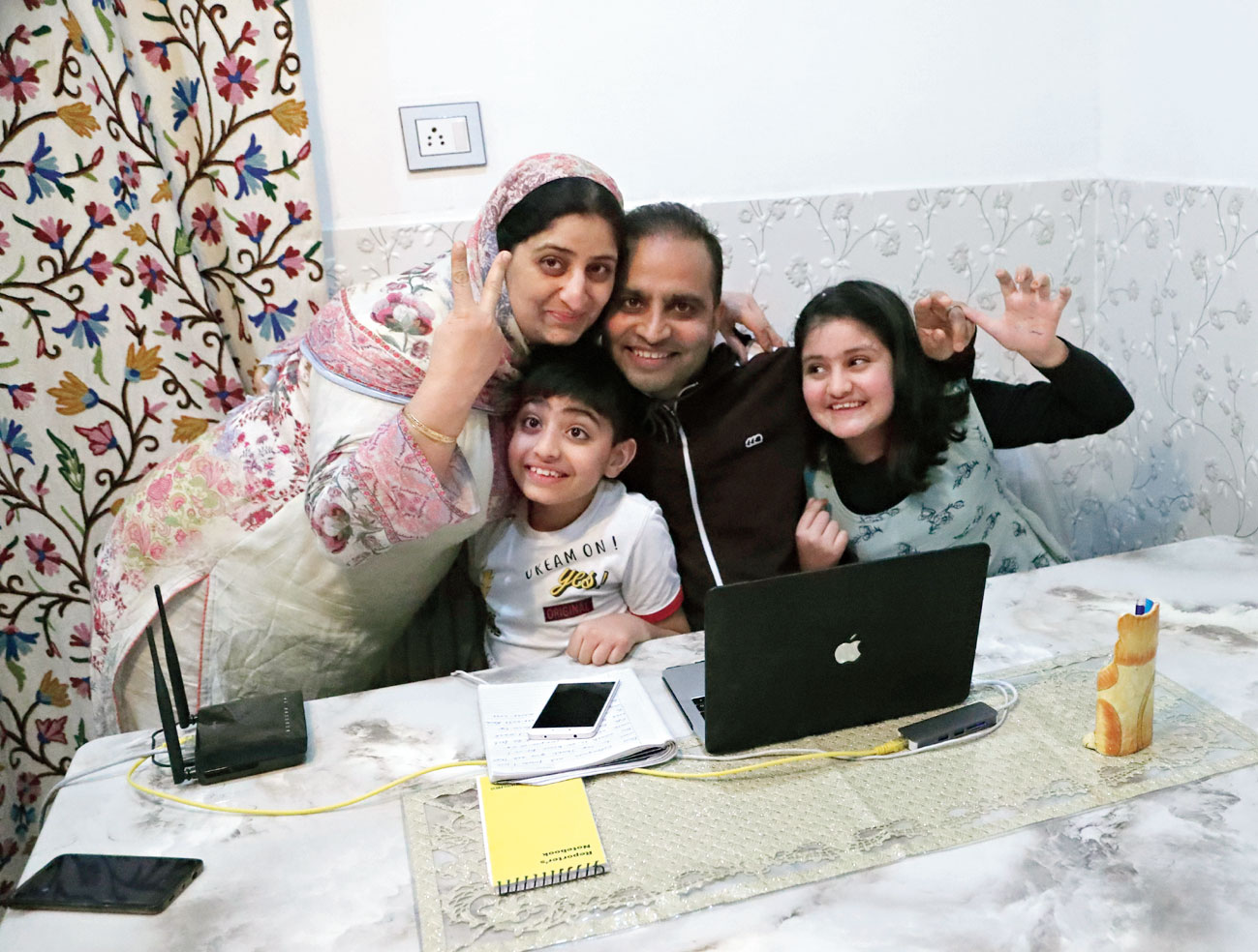 Associated Press photographer Mukhtar Khan celebrates with his family at his home in Srinagar.